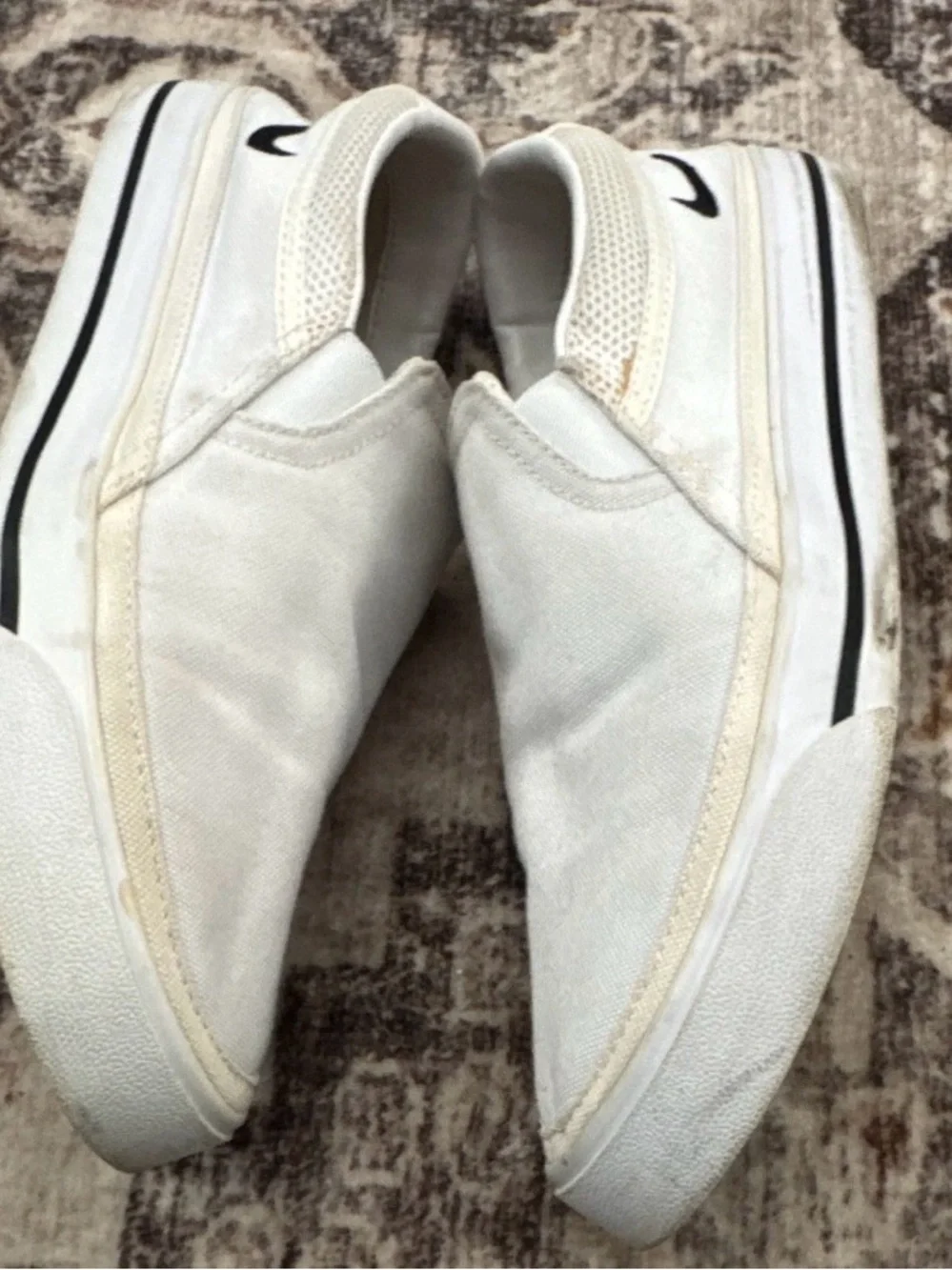 Nike Women’s White Slip-On Sneakers with Black Swoosh Accent